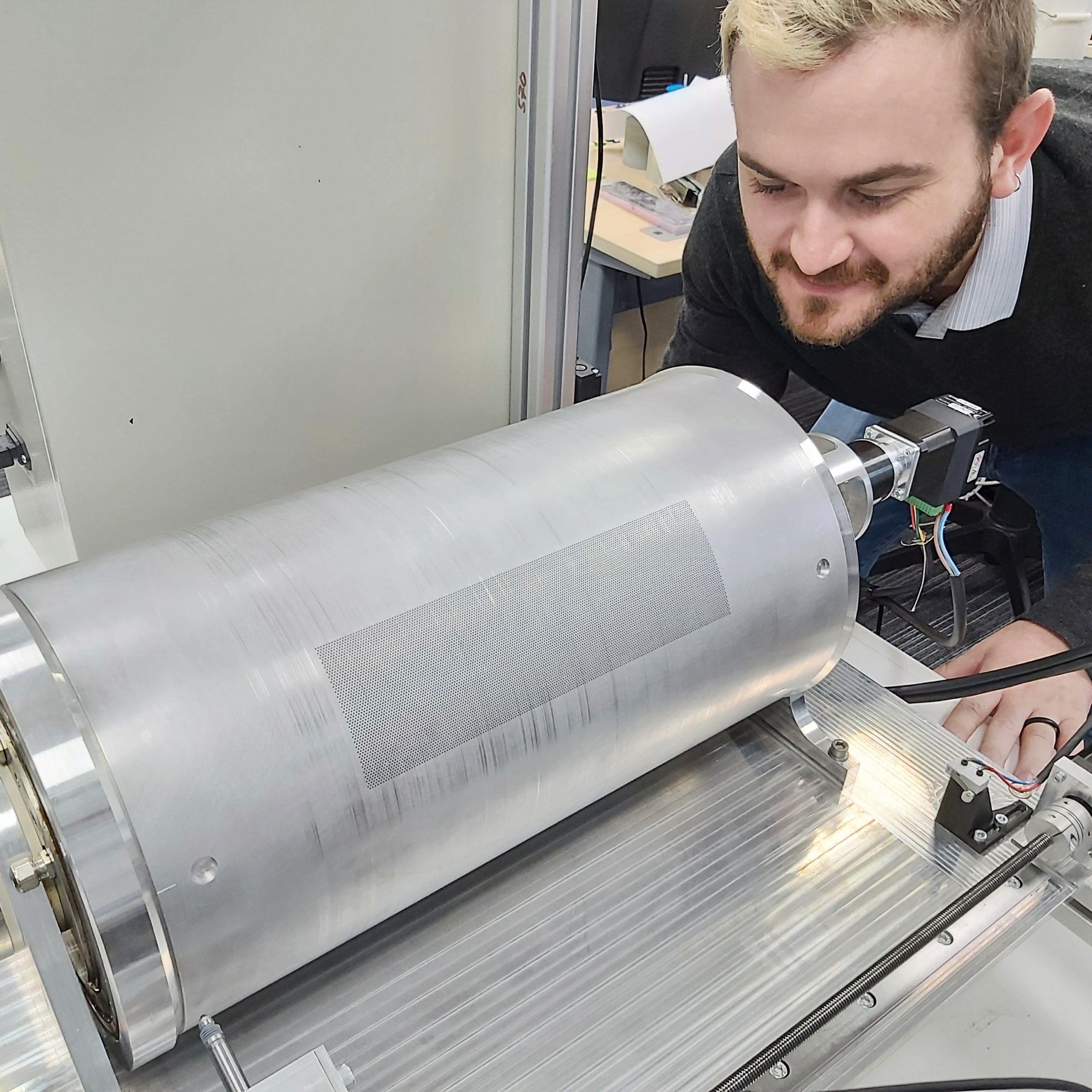 Image of a man with blonde hair testing a silver Powerdrop drum