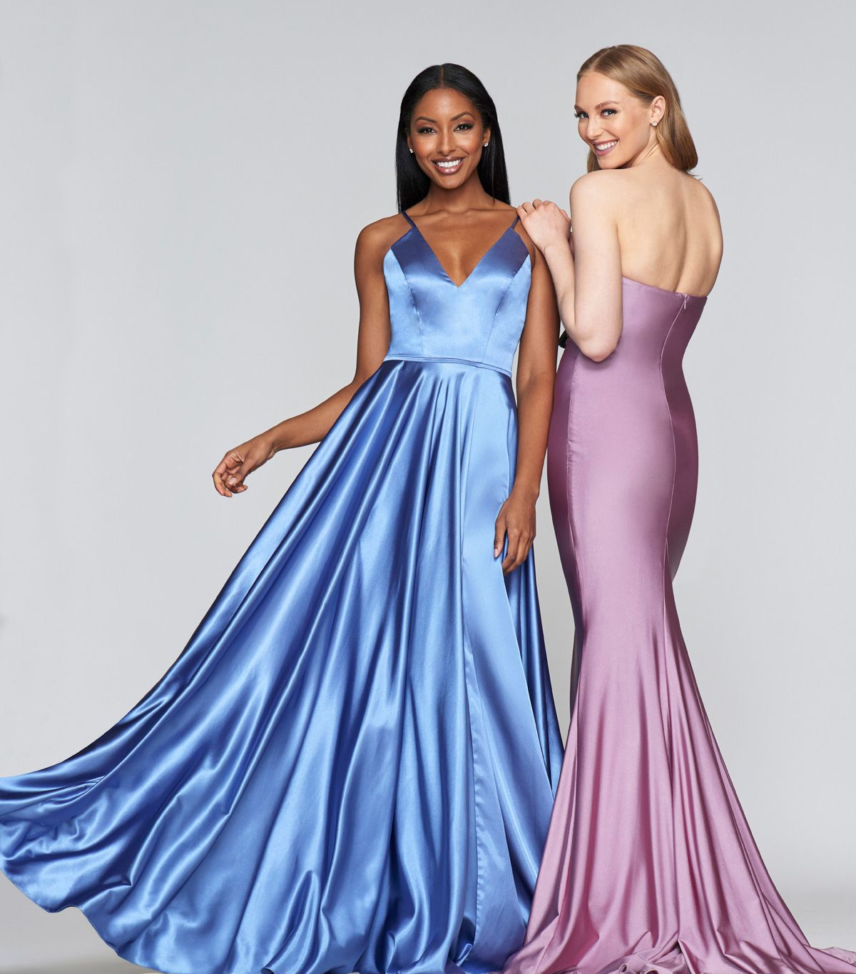 Image of two models in satin full-length dresses